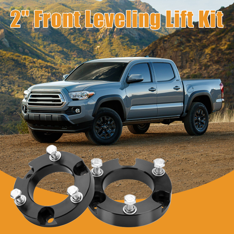 Modified off-road vehicle with upgraded front lift kit and oversized tires, driving on rough terrain with improved ground clearance